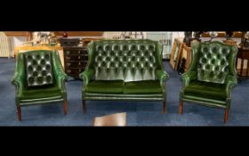 A Three Piece Button Back Green Leather Chesterfield to include a two seater high winged back and