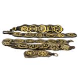 Large Amount of Antique Horse Brasses suspended on leather straps, five in total, each 24 inches