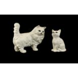 Two Beswick White Persian Cat Figures. The larger standing cat measures 6" long x 5" tall.