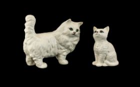 Two Beswick White Persian Cat Figures. The larger standing cat measures 6" long x 5" tall.