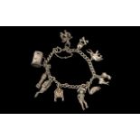 Silver Charm Bracelet loaded with some interesting charms, skull and crossbones, deep sea diver etc.