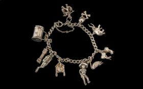 Silver Charm Bracelet loaded with some interesting charms, skull and crossbones, deep sea diver etc.