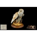 Franklin Mint 'The Barn Owl' Figure raised on a wooden base, with original documents. Measures 9.