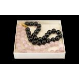 Two Heavy Jadeite Beaded Necklaces. Two beaded necklaces, one in black heavy jadeite with a gold