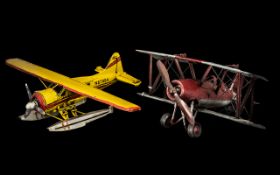 Two Tin Painted Model Aeroplanes measuring 14 and 11 inches.