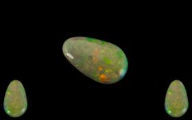 Ethiopian Natural Pear Shaped Green / Orange Opal. 3.07 cts. Measurements 20.1 x 12.2 x 3.3 mm.