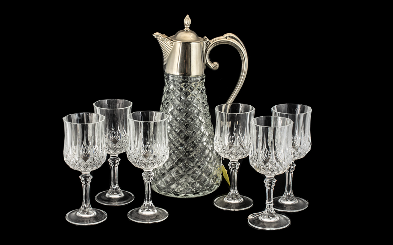 Drinker's Interest - A Large Cut Glass Lidded Wine Jug with plated lid and handle,