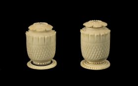 Pair of Anglo Indian Carved Ivory Pepperettes, c1860s, with screw petal shaped lids, on a round