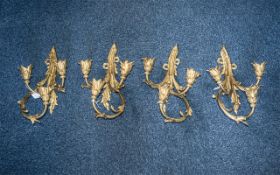 A Set of Four Three Branch Wall Sconces/Lamps of scrolling Acanthus form with cast flower bud