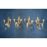 A Set of Four Three Branch Wall Sconces/Lamps of scrolling Acanthus form with cast flower bud