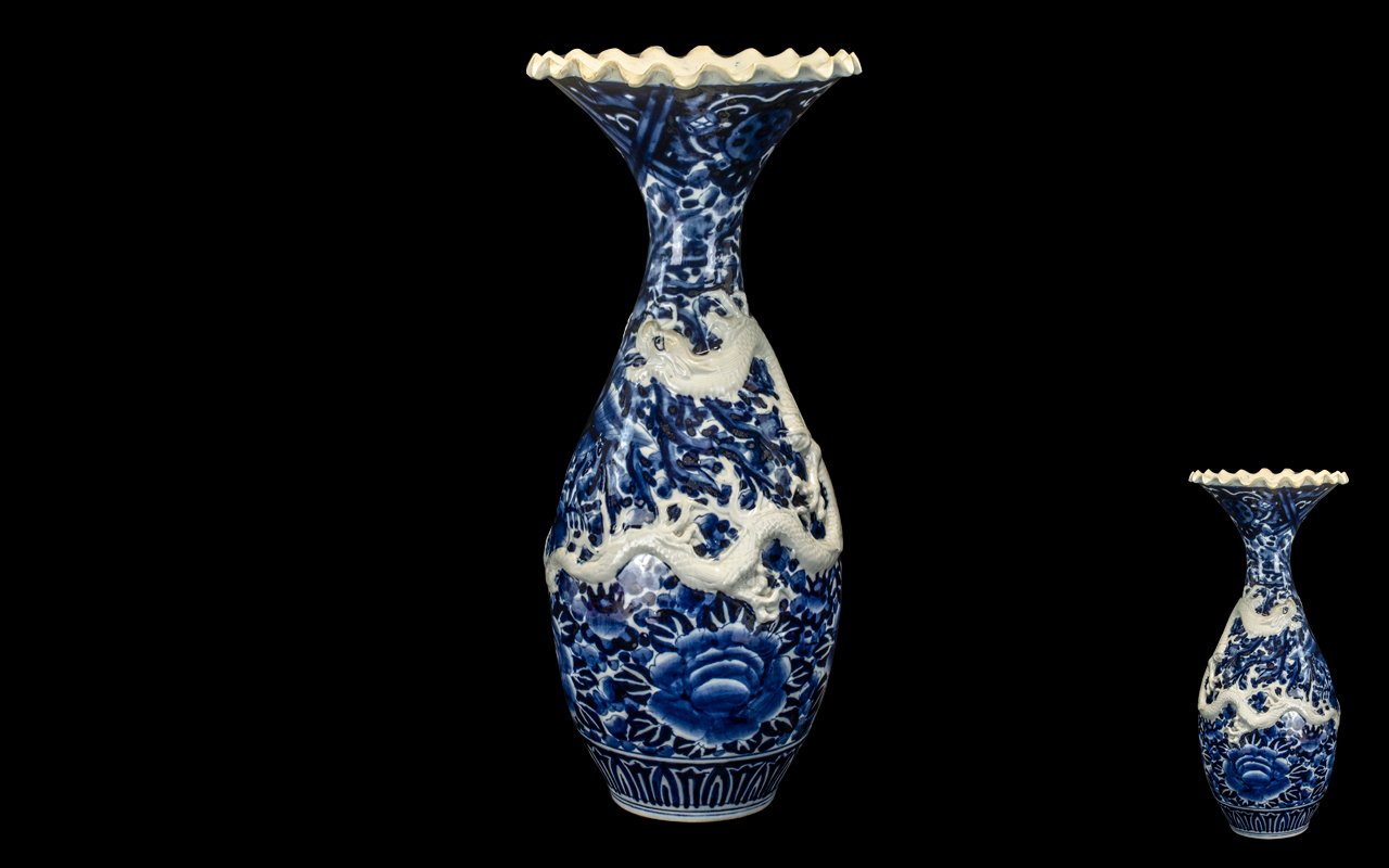 Large Japanese Meiji Period Embossed Dragon Vase with floral decoration in underglaze blue and an