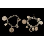 Two Silver Charm Bracelets with various medallions and trinkets attached, with heart shaped locks;