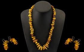 A Modern Reconstituted Amber Free form Necklace. Length 22 inches. Together with a pair of amber