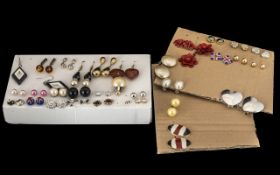 Collection of Earrings on pads. Please see photograph.