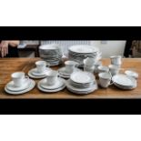Large Dinner/Tea Service in Fine Porcelain, in white ground with delicate floral trim,