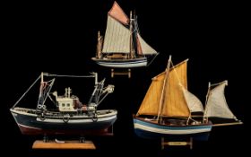 Three Decorative Boats on Stands two fishing trawlers and a yacht.