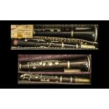 Two Vintage Clarinets, both in hard shell leather cases, with spare reeds. Maker F. Buisson of