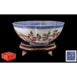An Oriental Eggshell Porcelain Bowl in original box and complete with wood stand.