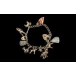 Solid Silver Charm Bracelet, with charms including a donkey with coloured gemstones, a Swallow,