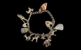 Solid Silver Charm Bracelet, with charms including a donkey with coloured gemstones, a Swallow,