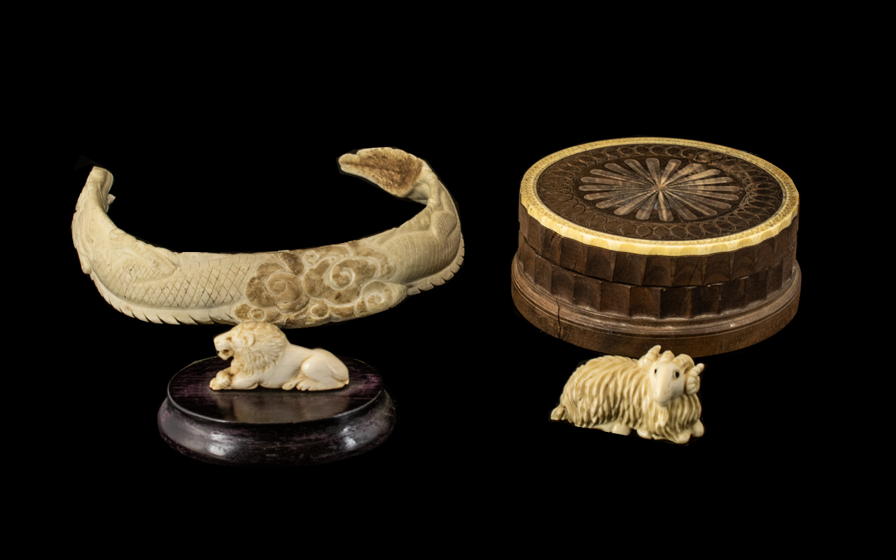 Antique Chinese Carved Boar's Tusk Necklace in the shape of a coiling dragon, a carved ivory netsuke