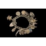 Solid Silver Charm Bracelet, loaded with charms, comprising: ballet shoes, jug, sixpence,poodle,
