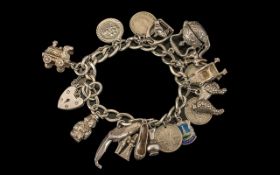 Solid Silver Charm Bracelet, loaded with charms, comprising: ballet shoes, jug, sixpence,poodle,