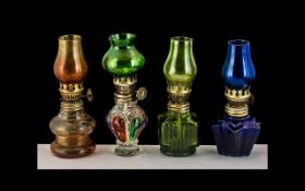 A Set Of Four Miniature Oil Lamps - Various Colours, Please See Acompanying Image.