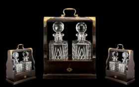 Two Bottled Reproduction Tantalus with mahogany frame,