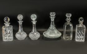 Collection of Cut Glass Decanters, comprising: Ship's decanter with decorative stopper 11'' tall;