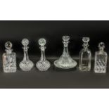 Collection of Cut Glass Decanters, comprising: Ship's decanter with decorative stopper 11'' tall;