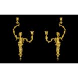 A Pair of Gilt Brass Rococo Style Figural Wall Sconces each with two scrolling branches.