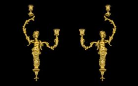 A Pair of Gilt Brass Rococo Style Figural Wall Sconces each with two scrolling branches.