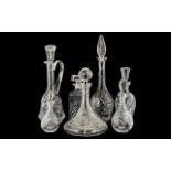 Collection of Seven Cut Glass Decanters with stoppers; various heights,