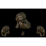 An Oriental Boxwood Netsuke in the form of a foo dog, well carved. Signed to underside.