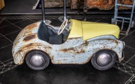 An Austin J40 Vintage Pedal Car circa 1950, painted blue with blue padded seat,