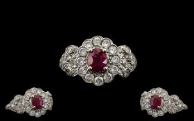 Ladies Attractive 18ct White Gold Ruby and Diamond Set Stylish Cluster Ring, the central ruby