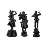 Three Antique French Patinated Spelter Figures depicting a man with a horn,