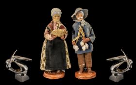 Pair of Pottery Figures of a Farmer and