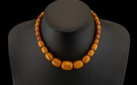 A Fine and Well Matched Graduated Butterscotch Amber Bead Necklace, with Hidden Clasp.