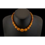 A Fine and Well Matched Graduated Butterscotch Amber Bead Necklace, with Hidden Clasp.