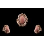 Pink Opal and Pink Sapphire Statement Ring, an oval cut cabochon of pink opal, measuring 7cts,