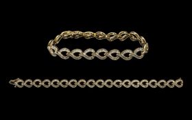 Ladies - Attractive 10ct Gold Baguette Diamond Set Tennis Bracelet of Contemporary Design. Marked