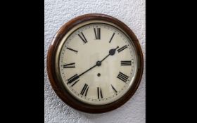 Circular School Clock mahogany case with enamel dial and Roman Numerals.