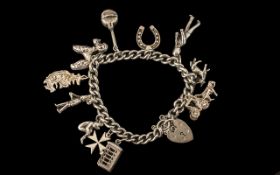 A Vintage Sterling Silver Charm Bracelet, Loaded with 11 Silver Charms.