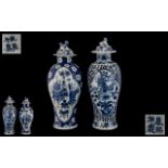 Two Antique Chinese Blue and White Lidded Vases, decorated to the body with birds and flowers,