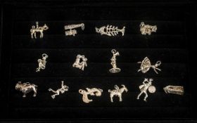 Collection of 14 Silver Charms comprising: a Sentry in his box; a Billy Goat; a Dancer; £ sign;