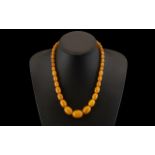 Natural Butterscotch Amber Graduated Bead Necklace with Gold Clasp. Weight 40.8 grams.