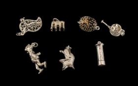 Collection of Seven Silver Charms comprising a hedgehog, a caterpillar on a leaf, a knight's helmet,