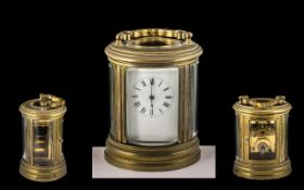 French - Late 19th Century Oval Shaped Brass Carriage Clock of Small Proportions and Heavy with